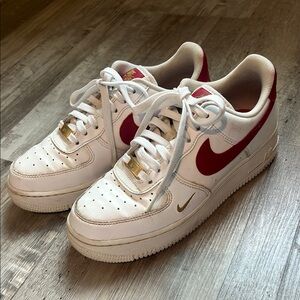 Nike Air Forces White Sneakers with Red and Gold Accents